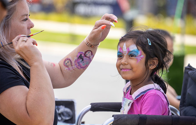 A child having their face painted at one of Riverlea’s community events.